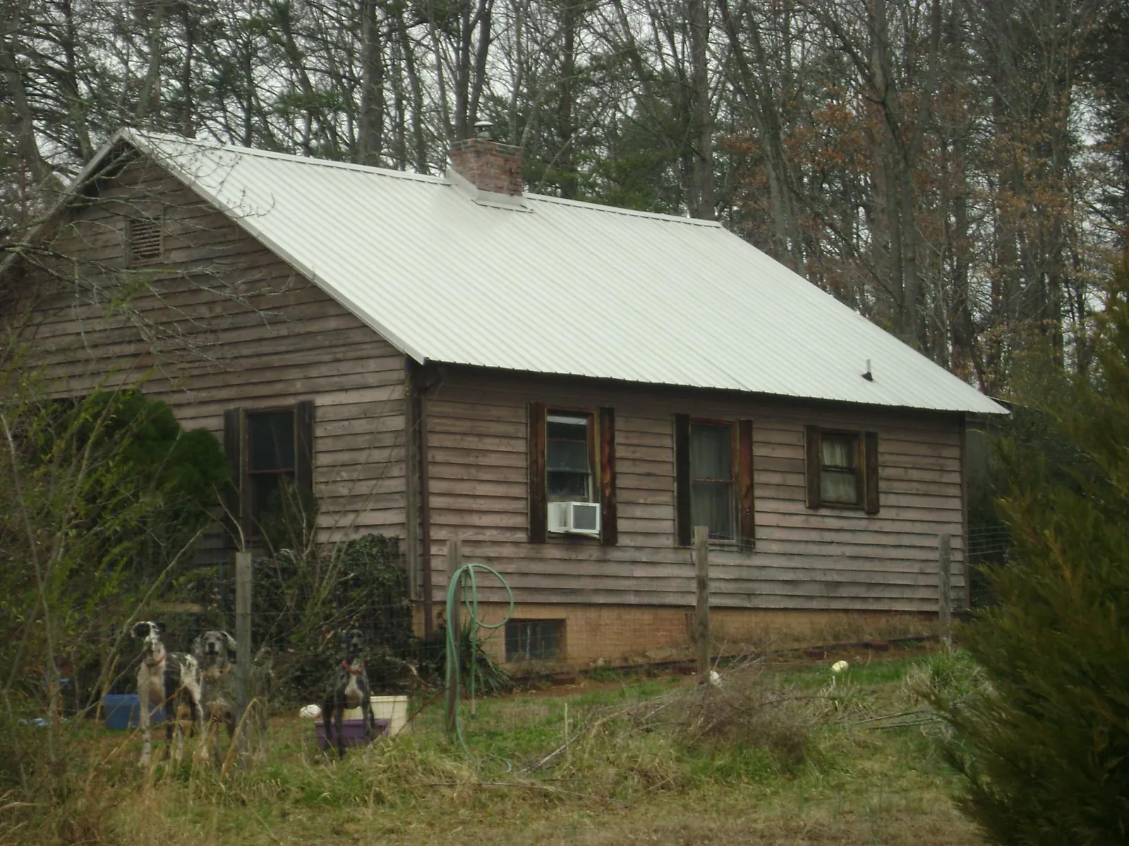 White metal roof on an old wood sided farmhouse, from a Asphalt Shingle Roof Repair job in Morris